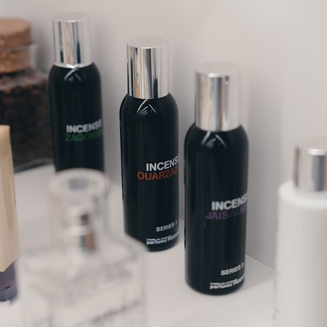 Bottles of Comme des Garçons Incense Series 3 perfumes with silver caps displayed on a white surface.