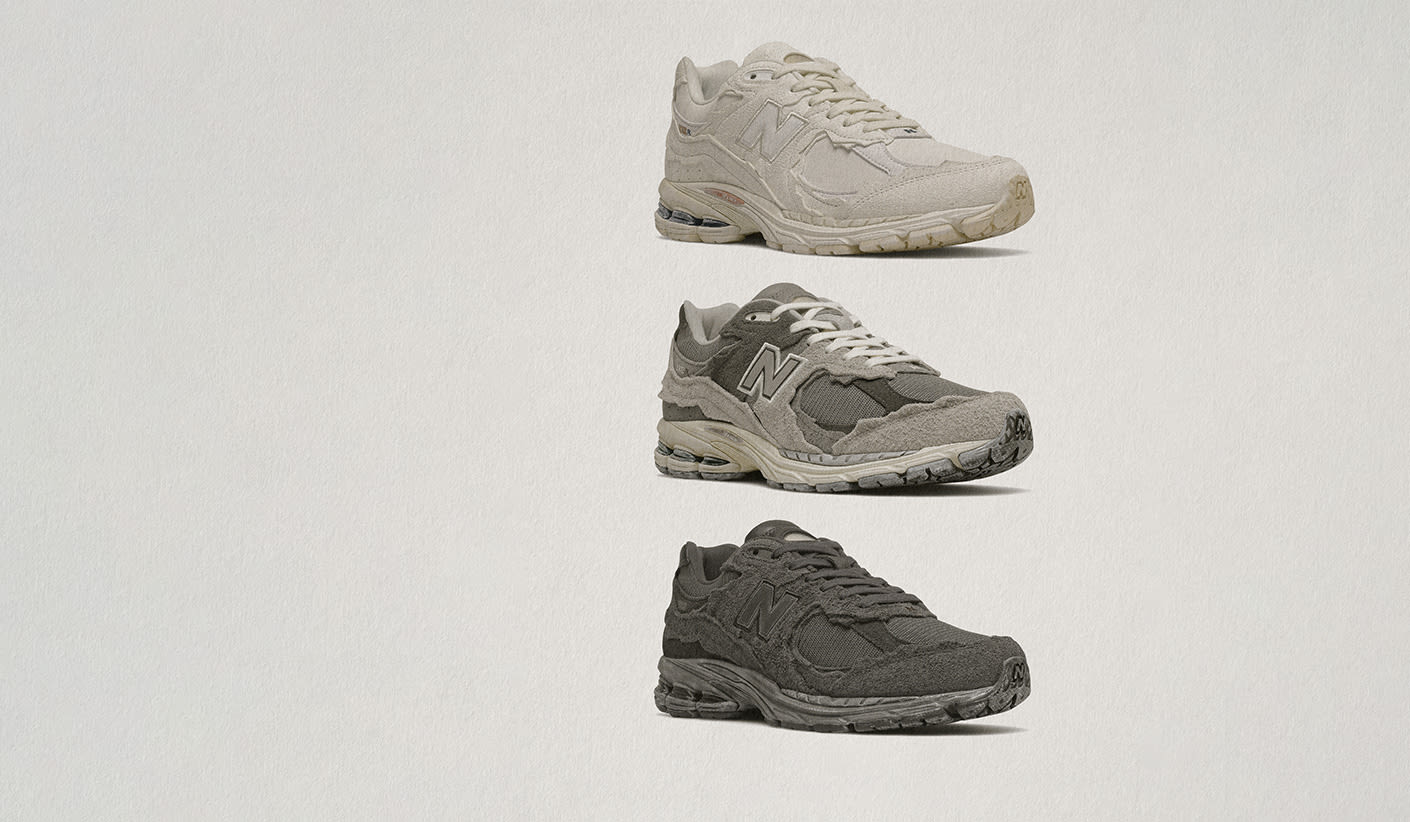 Three pairs of New Balance 2002R Protection Pack sneakers displayed vertically on a light background. The top pair is in a cream colorway, the middle pair is grey with white laces, and the bottom pair is in a dark charcoal shade.