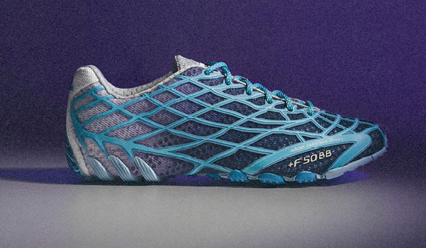 Close-up of the adidas x Bad Bunny World Cup F50 sneaker in blue and purple tones, featuring a distinctive mesh cage upper and low-profile silhouette against a purple background.