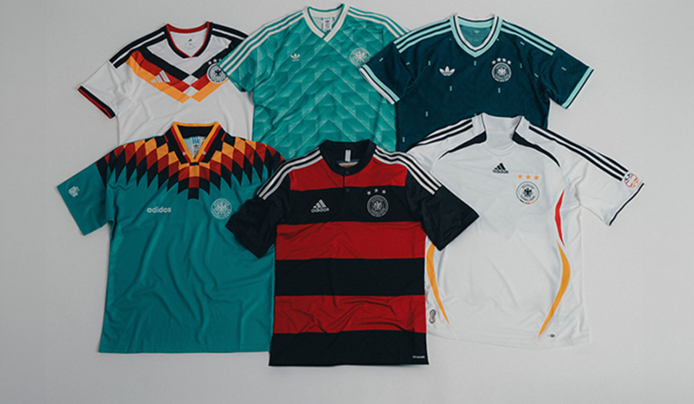 Six adidas DFB Germany jerseys displayed flat on a neutral background, featuring a mix of retro and modern designs in white, green, teal, black, and red, each with distinctive patterns, three stripes, and the Germany crest.