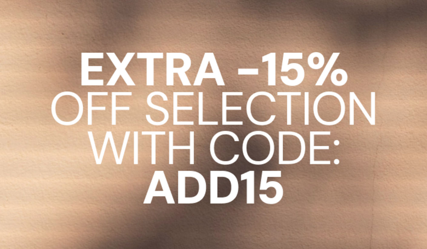 Promotional banner offering an extra 15% off selected items with discount code ADD15, displayed on a beige background with soft shadow patterns.