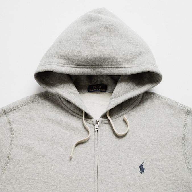 Flat lay of four jackets in different styles and colors: a black puffer jacket with Nike ACG logo, a dark green corduroy Carhartt jacket, a brown Carhartt hooded work jacket, and a black hooded jacket.