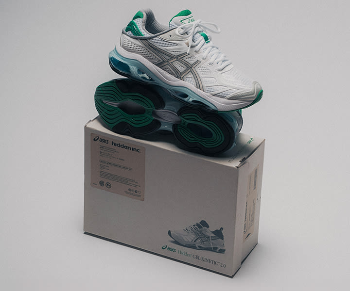 ASICS x Hidden NY Gel-Kinetic 2.0 sneakers in white mesh with silver overlays and green accents, displayed on top of a branded shoebox against a clean studio background.