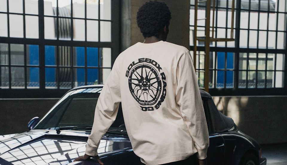 Solebox Race Capsule longsleeve with wheel back print next to a sports car