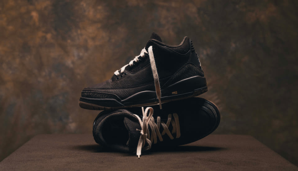Air Jordan 3 Retro "Fireside" CK9246-200 in black leather with tonal elephant print details, photographed in a premium studio setting with warm brown backdrop and stacked sneaker composition