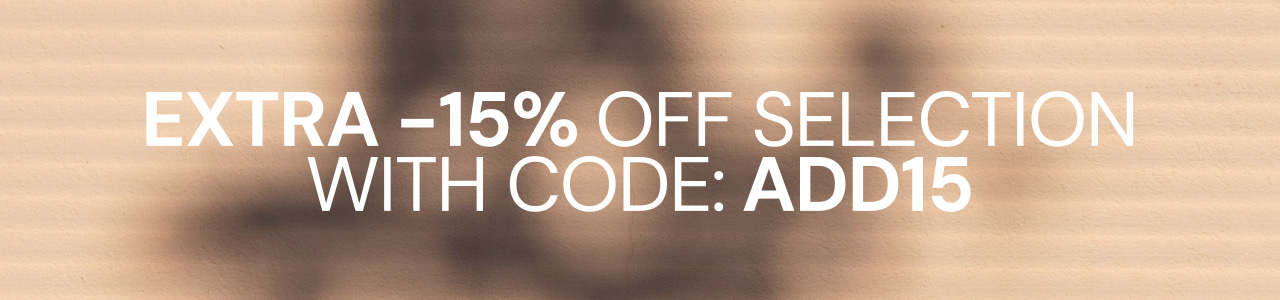 Promotional banner offering an extra 15% off selected items with discount code ADD15, displayed on a beige background with soft shadow patterns.
