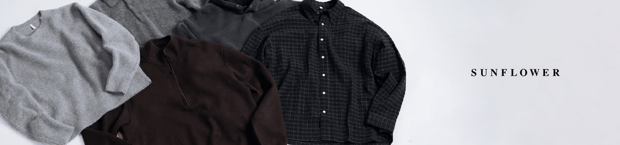 Flat lay of five folded men's tops in neutral tones displayed on a light background. The items include a light grey crewneck sweater, a grey knit polo shirt, a charcoal grey hoodie, a dark brown quarter-zip pullover, and a black button-up shirt with a subtle grid pattern. The garments are arranged in a fan-like composition, evoking a minimalist and refined aesthetic.