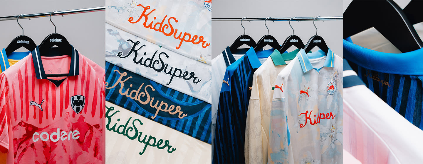 A row of colorful Puma football jerseys hanging on black Solebox hangers.