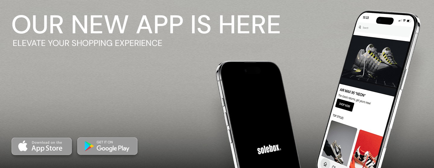 Banner showing two tilted smartphones with a shopping app interface and Solebox logo, text “Our New App Is Here – Elevate Your Shopping Experience” and App Store / Google Play download buttons on a grey background.