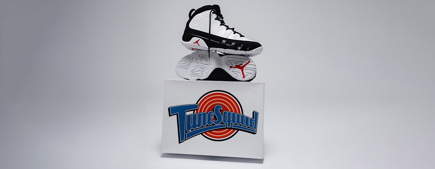 Air Jordan 9 "Space Jam" sneaker in black and white displayed on a Tunes Squad box, highlighting the silhouette and outsole with red Jumpman details against a clean white background.