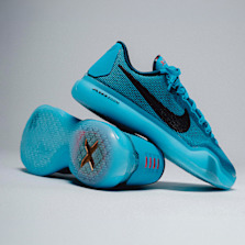 Nike Kobe basketball sneakers in bright blue with black Swoosh details and translucent soles.