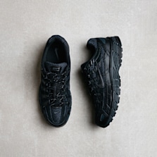 Pair of all-black Nike P-6000 sneakers displayed on a light-colored textured surface.