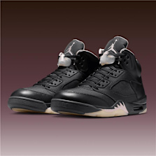Pair of Air Jordan 5 x Paris Saint Germain “Off Noir” sneakers in black leather with translucent lace locks and off‑white icy soles, displayed on a gradient brown background.