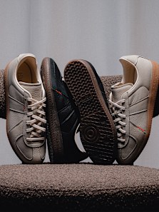 adidas BW Army sneakers in beige and black leather with gum soles, arranged in a minimal studio setting.