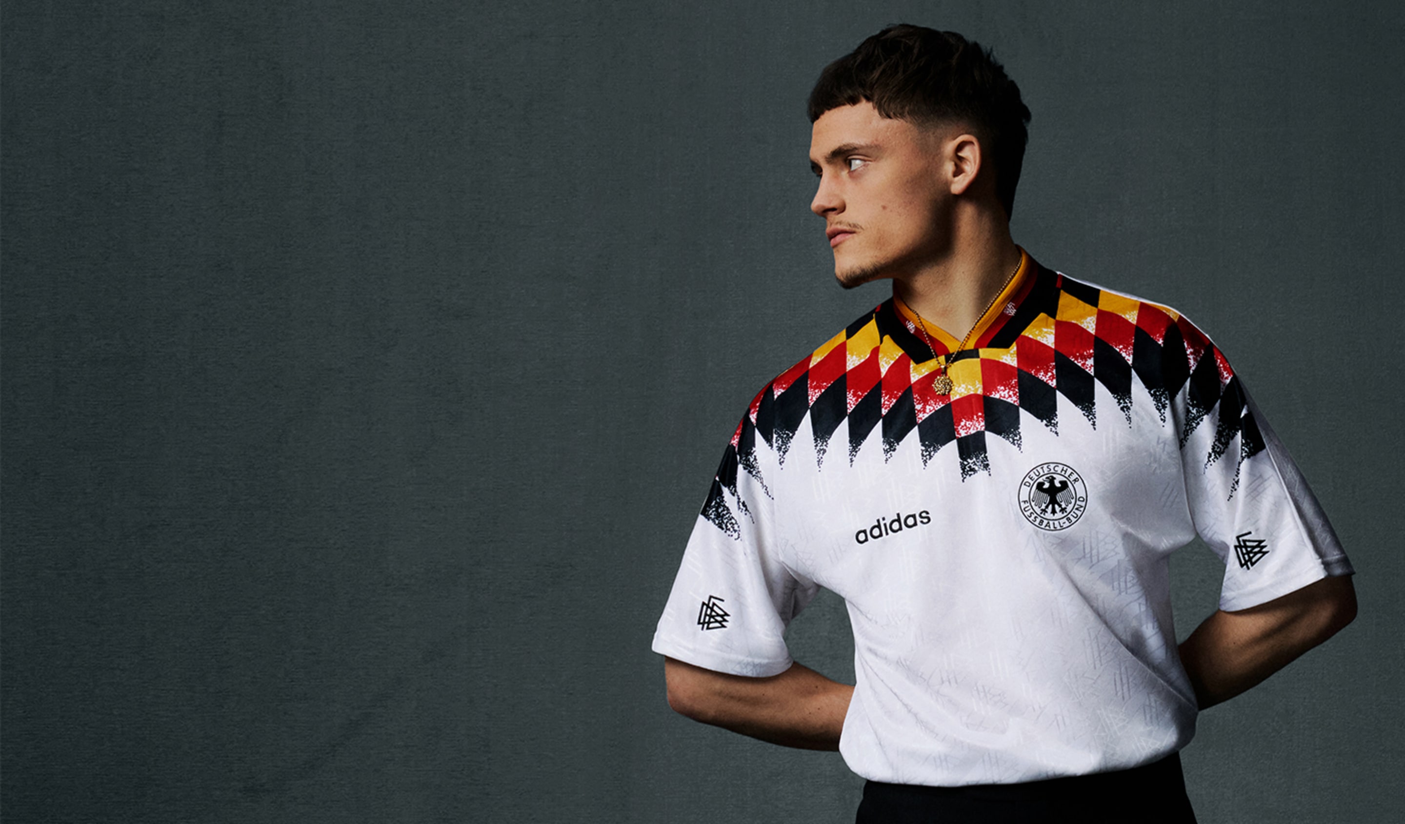 adidas 1994 World Cup jersey in white with bold black, red, and yellow geometric pattern, shown in a studio portrait.