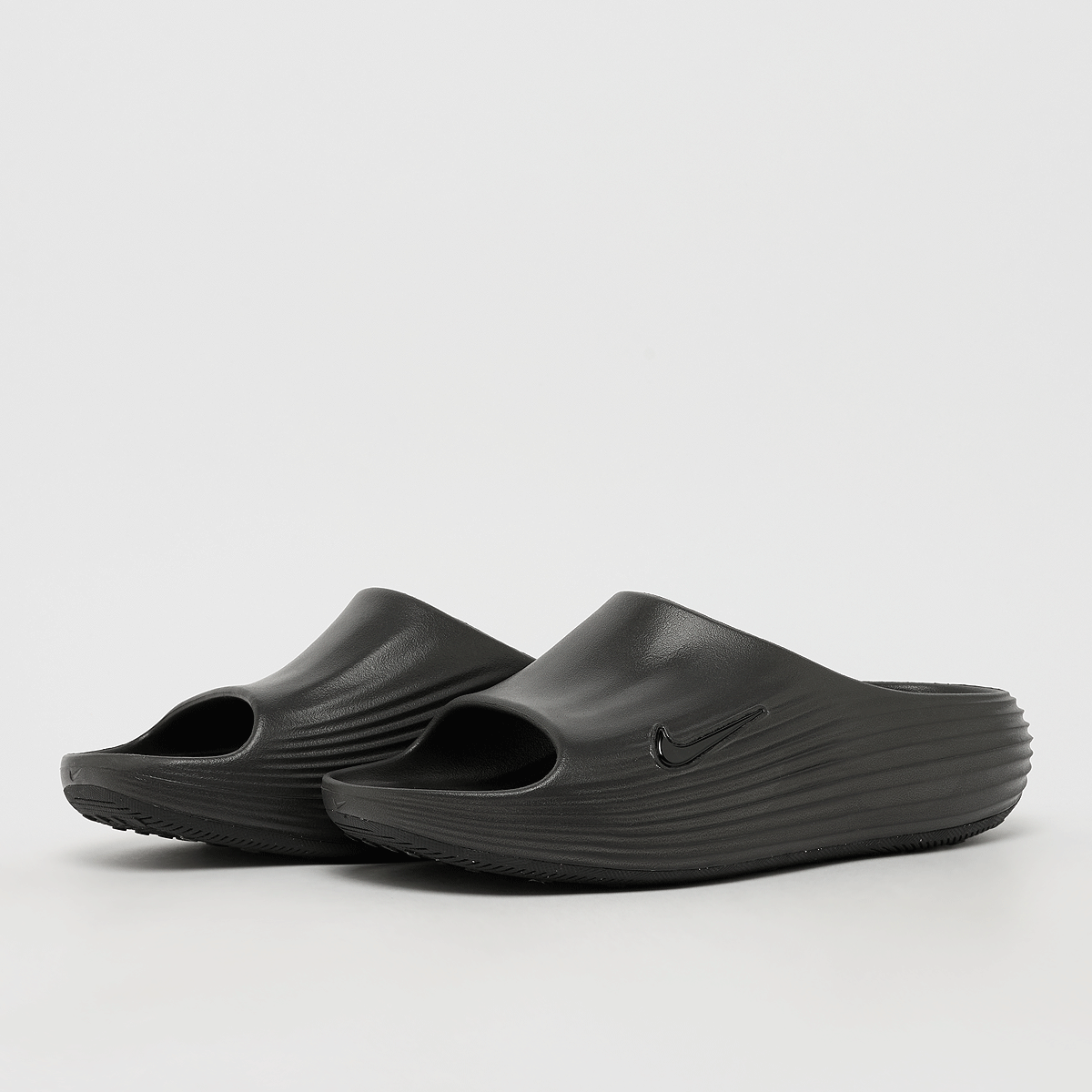 Buy Nike Reactx Rejuven8 Slide in black | HV4479-001 at MBCY