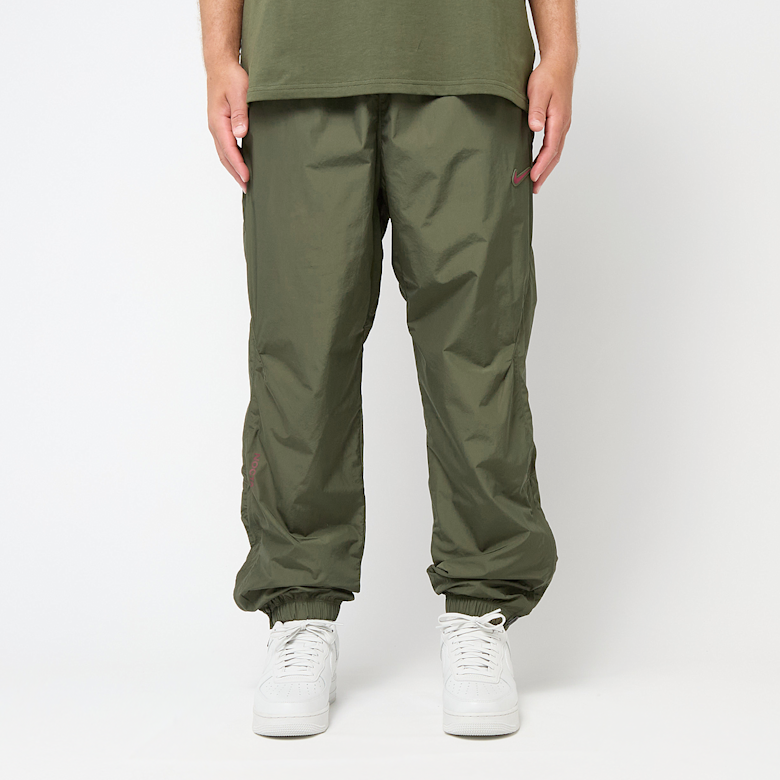 Buy Nike x Nocta NRG Woven Track Pants in cargo khaki/team red